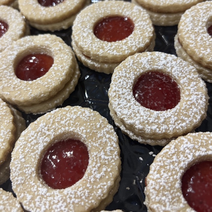 strawberry jam sandwich cookies dusted with powdered sugar